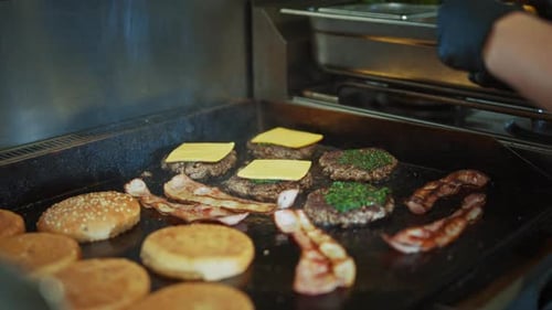 Adding Cheese to Burger on Grill with Bacon