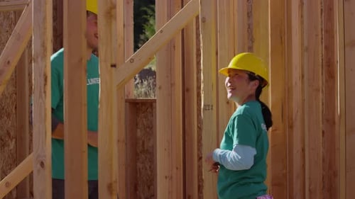 Volunteers Building a House Frame on a Sunny Day