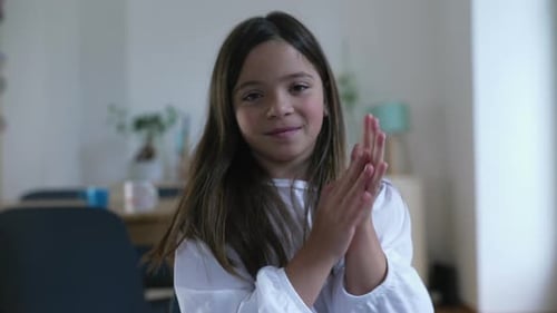 Cute Smiling Girl Clapping Hands in Room