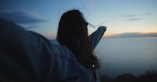 Happy Woman Enjoying Freedom Standing on the Hill with Raised Hands