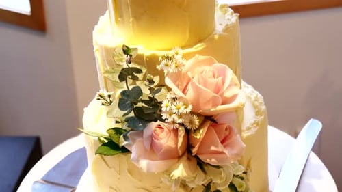 Wedding cake decorated with roses, celebration indoors