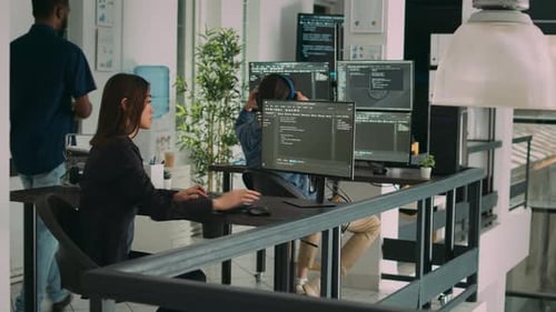 Database Developer Using Computer to Write Code on Terminal Window