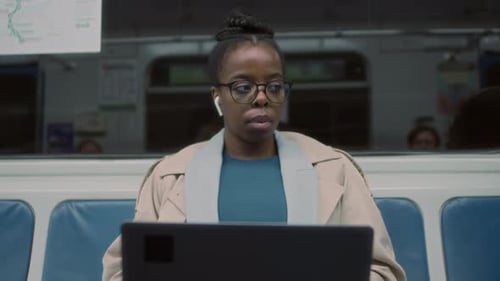 Freelancer Working on Laptop Computer in Public Transit Metro Train