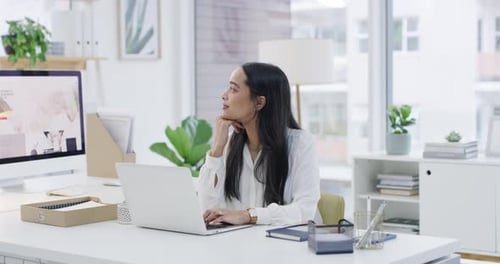 4k video footage of a young businesswoman using a laptop in a modern office