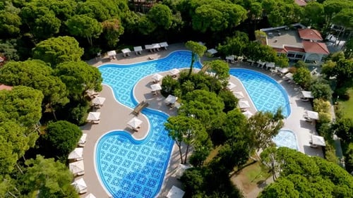 Luxurious Beach Resort with Swimming Pool and Beach Chairs and Palm Trees