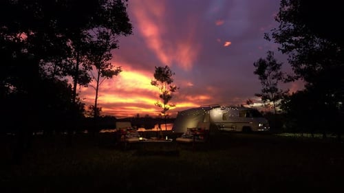 Peaceful Camping Scene with Camper Van at Sunset by the Lake