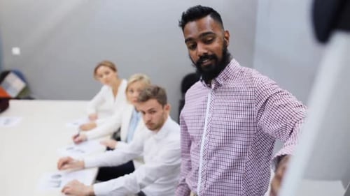 Multiethnic business team brainstorming startup strategy at office presentation