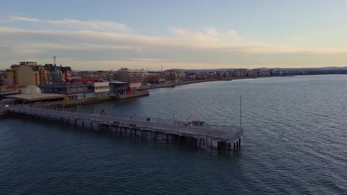 Side View of the Pier on the Black Sea Against the Background of the Sky and Sunset