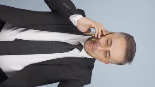 Man in Suit Talking on Cell Phone