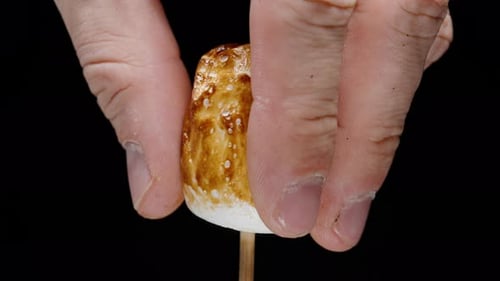 Squeezing a Toasted Marshmallow on a Stick