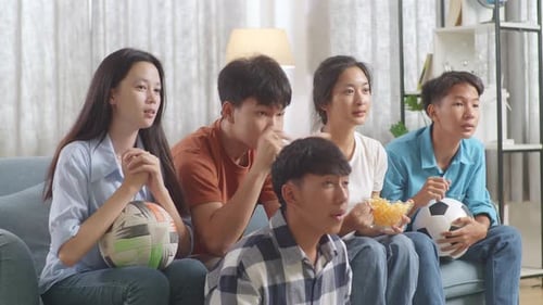 Teenagers Cheering And Watching Football Game On Tv. Team Celebrating Victory And Team Disappointed