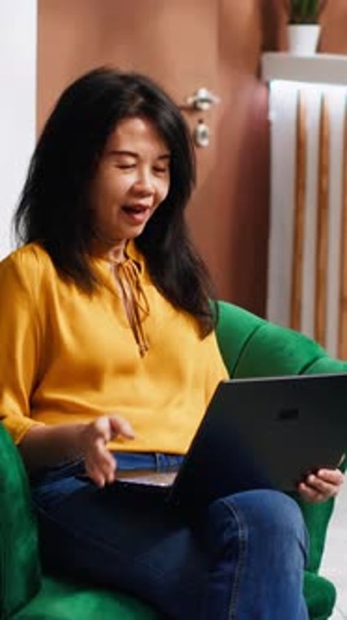 Vertical Video Asian Hotel Guest on Videocall with Family Members
