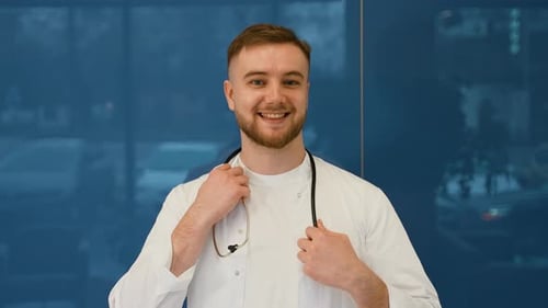 Smiling Young Doctor in White Coat with Stethoscope