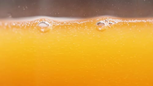 Close Up Of Bubbles In Orange Liquid