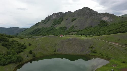 Flight over a mountain lake against the backdrop of epic beautiful rocks. Aerial view.