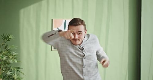 Ecstatic Excited Male Winner Dancing in Office Hallway Laughing Celebrating Work Achievement