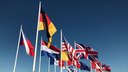 Flags of the World Waving Against Blue Sky