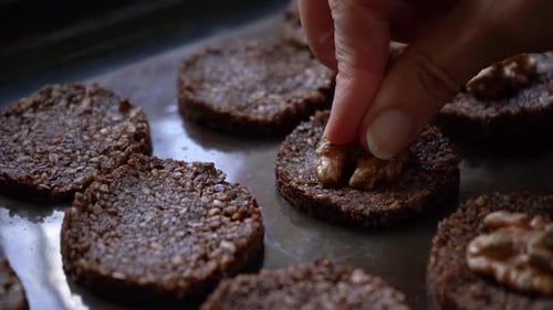 Healthy Cookies Made Of Bitter Cocoa And Seeds Top With Fresh Walnuts. Close Up