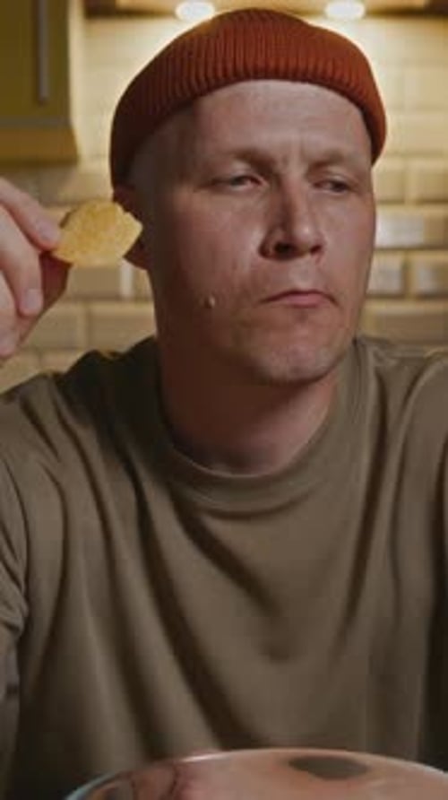 CloseUp of Man Eating Chips