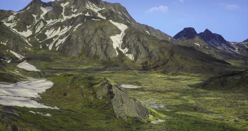Vast Mountain Landscape with Greenery Under a Clear Blue Sky During Daylight
