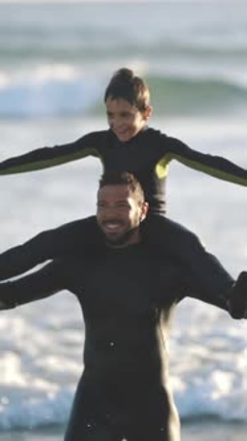 Father and Son play at beach during day