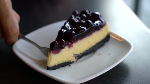 Close Up of Eating Blueberry Cheesecake Slice