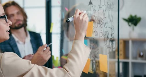 Close up of professional man and woman colleagues analyzing business strategy of joint project