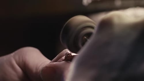 A Woman Jeweler Polishes Jewelry