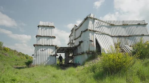 Man Walking Toward Shipping Container Home