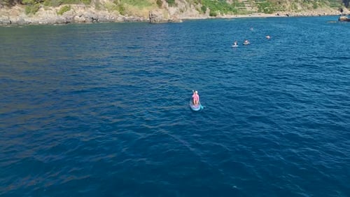 Aerial View Magical Beach With Clear Waters People Enjoy Swimming Sunbathing and Paddleboarding