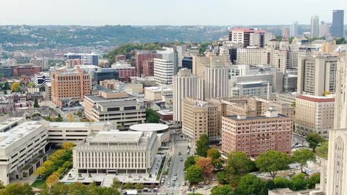 Dramatic aerial tilt up reveals Pitt campus and Cathedral of Learning, University of Pittsburgh. Urb
