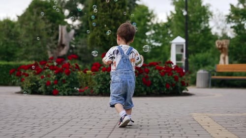 Toddler Playing with Bubbles in a Park Garden