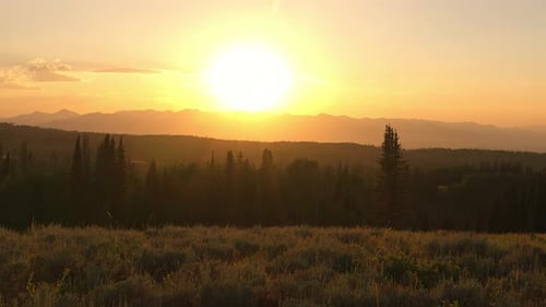 Majestic Mountain Sunset Over Forest Landscape