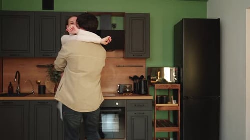 Happy Couple Hugging in Modern Kitchen