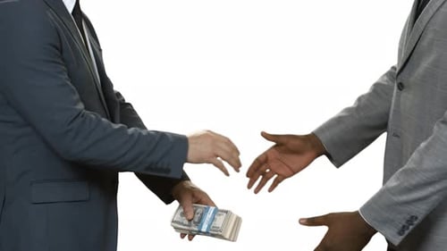 Businessmen with Cash Shaking Hands