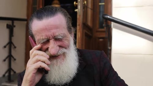 Smiling Senior Man Talking on Cell Phone Outside