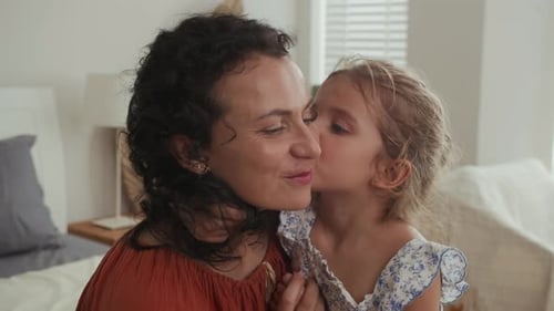 Loving Mother and Daughter Embrace Indoors