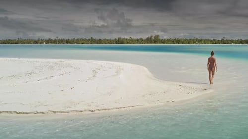 Woman Walking on a White Sand Tropical Beach in Paradise Lagoon