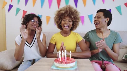 Friends Celebrate Birthday With Cake and Candles