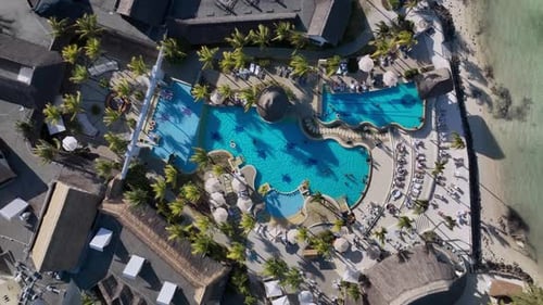 Top Down View Of The Resort Pool With Sun Beds On The Coast