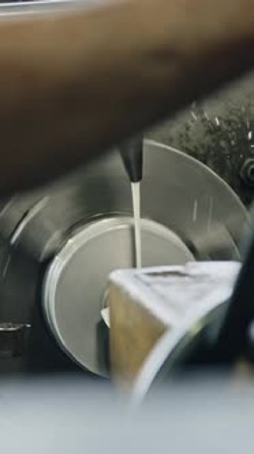 Expert machinist using lathe machine for precise metalwork in industrial setting