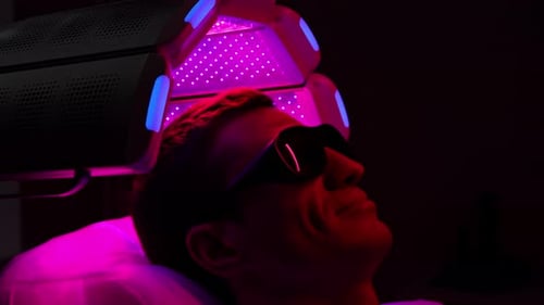 Man Lying in Purple Tanning Bed