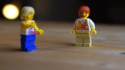 Toy figures stand on wooden surface