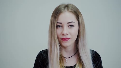 Blonde Woman Smiling Gently In a Close Up