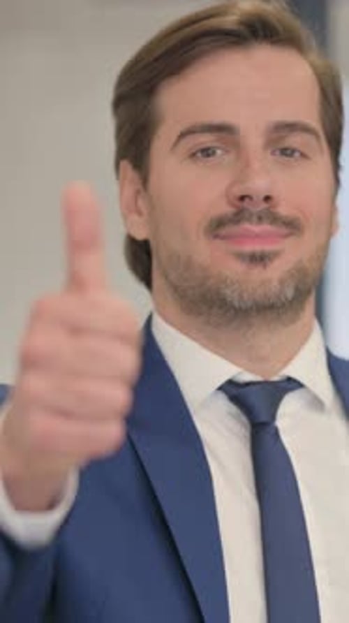 Portrait of Young Businessman with Thumbs Down, vertical video