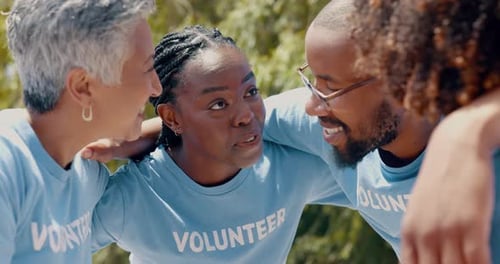 Diverse Volunteers Smiling Together Outdoors in Nature