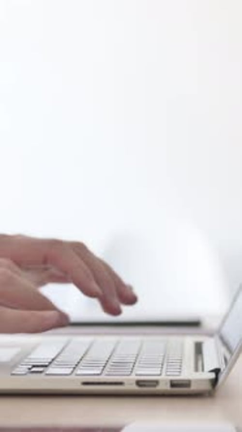 Close Up of Male Hands Typing on Laptop, Side View, Vertical Video