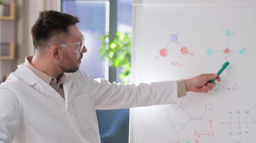 Distance Education, School and Science Concept - Male Chemistry Teacher with Laptop