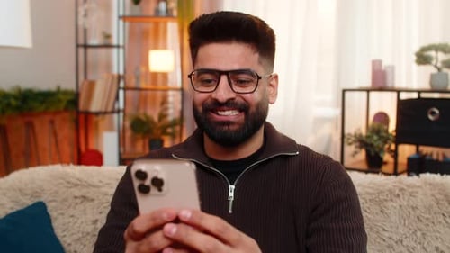 Excited man celebrating good news on his phone