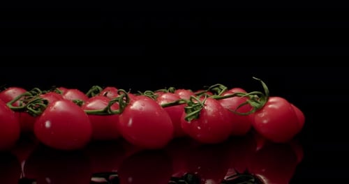 Juicy red cocktail tomatoes super close-up with dark background unique high resolution 4k shoot Glos